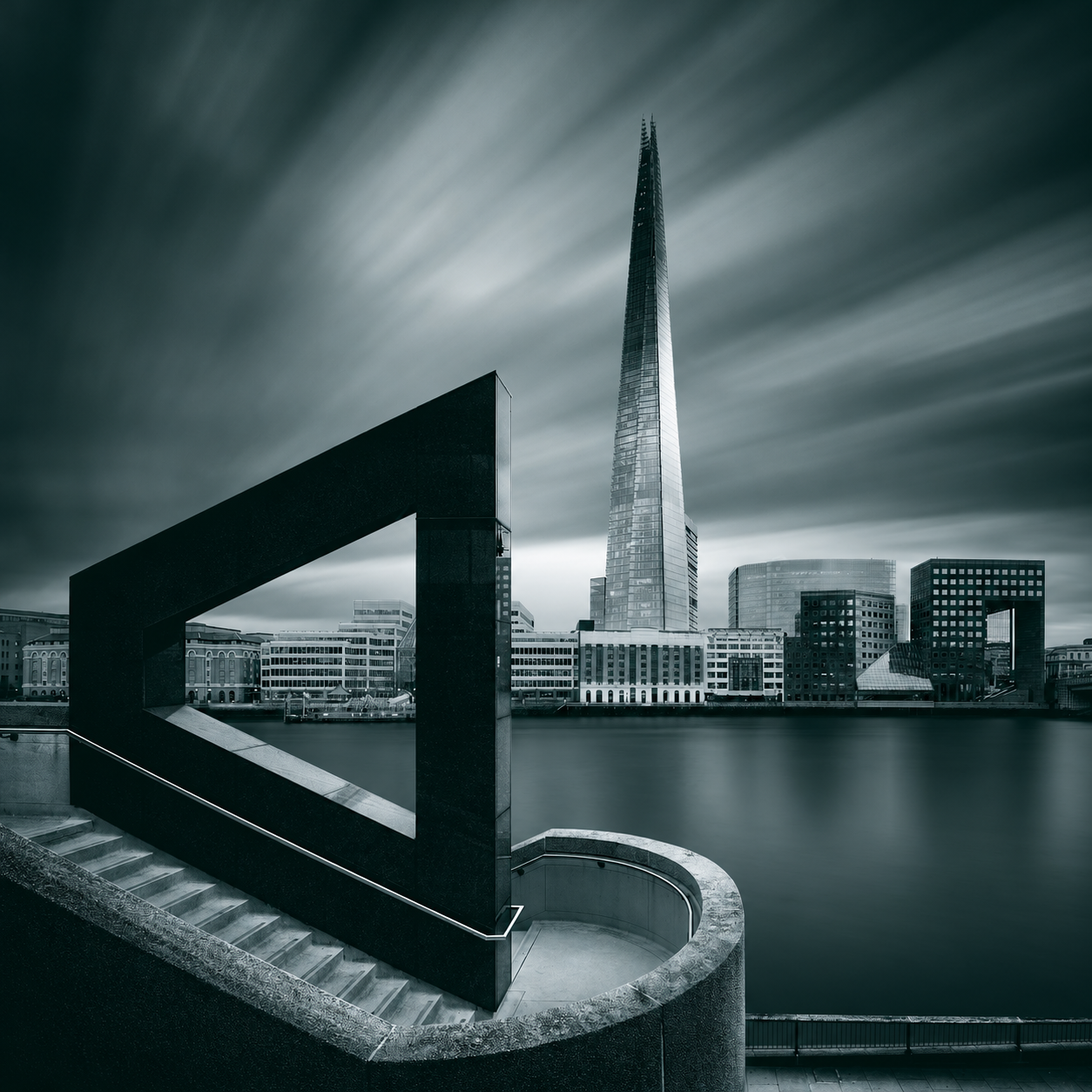 The Shard and London riverfront framed by monumental architecture