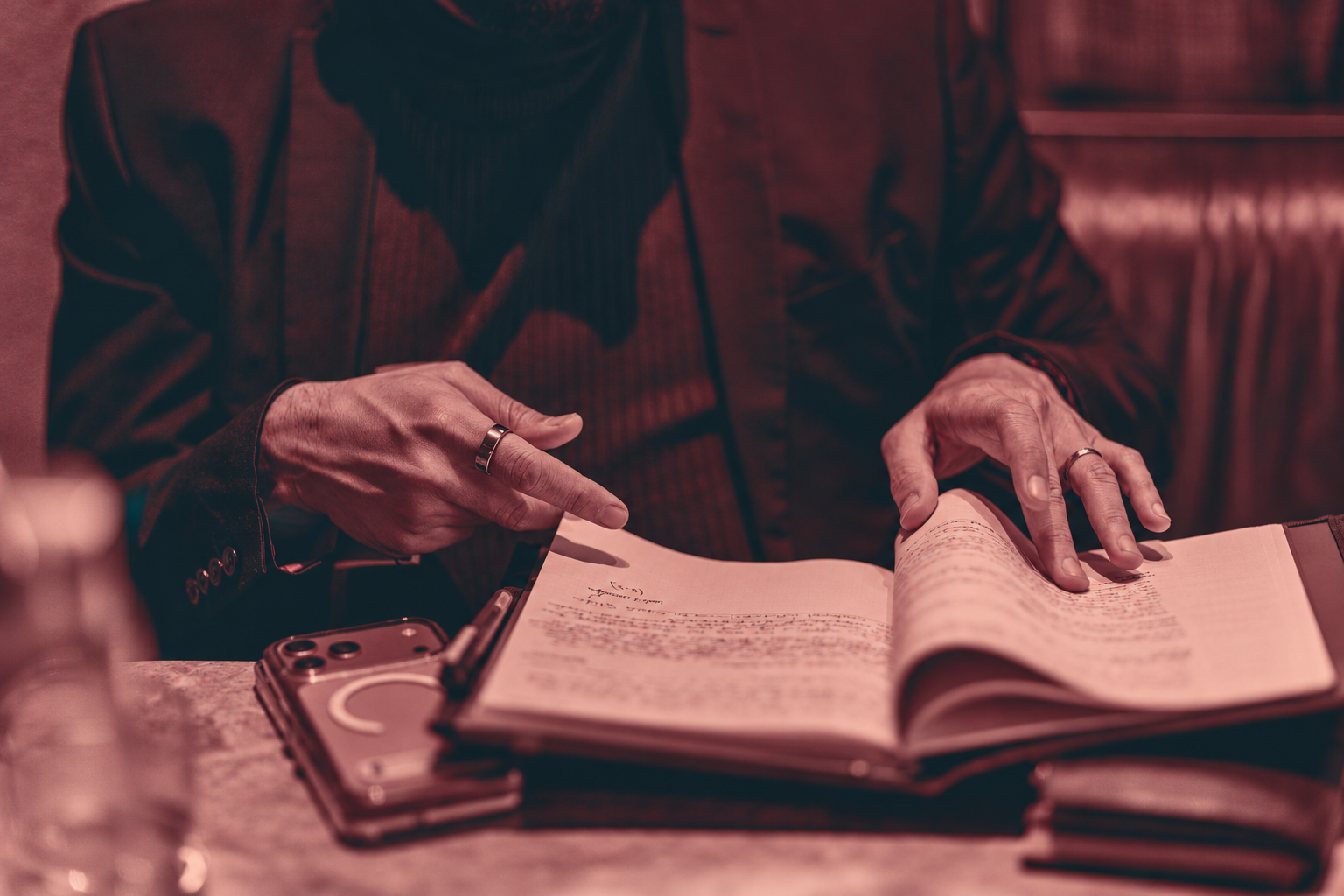Dillan Gandhi making notes in a notebook