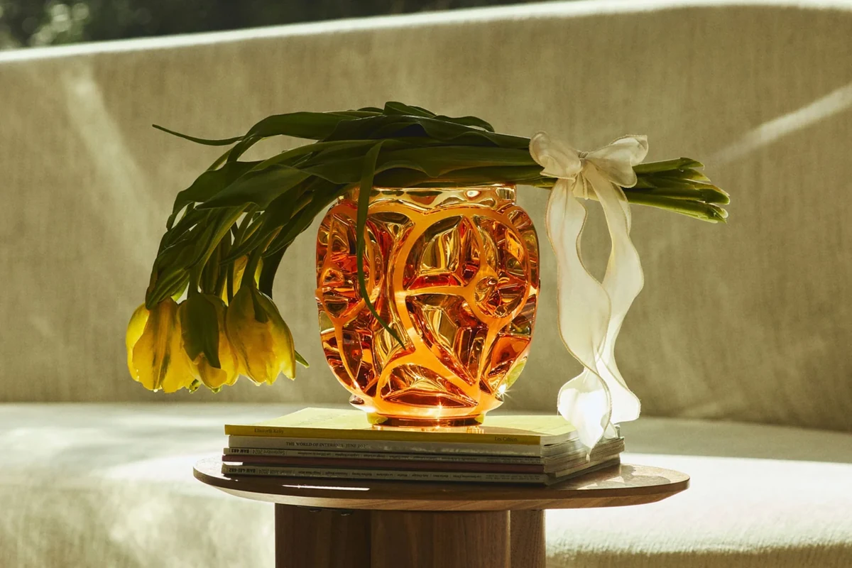A decorative glass vase with yellow tulips
